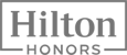The image is a logo for Hilton Honors, featuring the words "Hilton Honors" in a stylized, rectangular design.